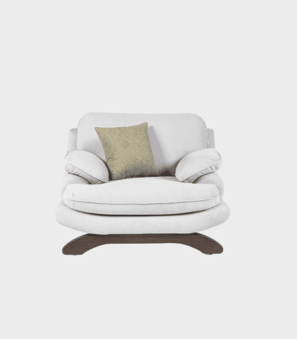 Sofá blanco con cojín beige y reposapiés, ideal para sala de estar y decoración moderna.