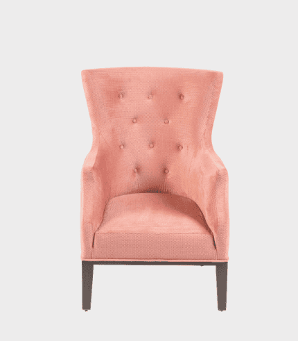 Sillón de estilo vintage en color rosa con tapizado acolchado y patas de madera oscuras, ideal para decorar espacios modernos y elegantes.