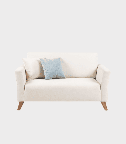 Chaiselongue beige con cojines decorativos, ideal para salón o sala de estar moderna y acogedora. Diseño elegante combina funcionalidad con estilo en muebles para el hogar.