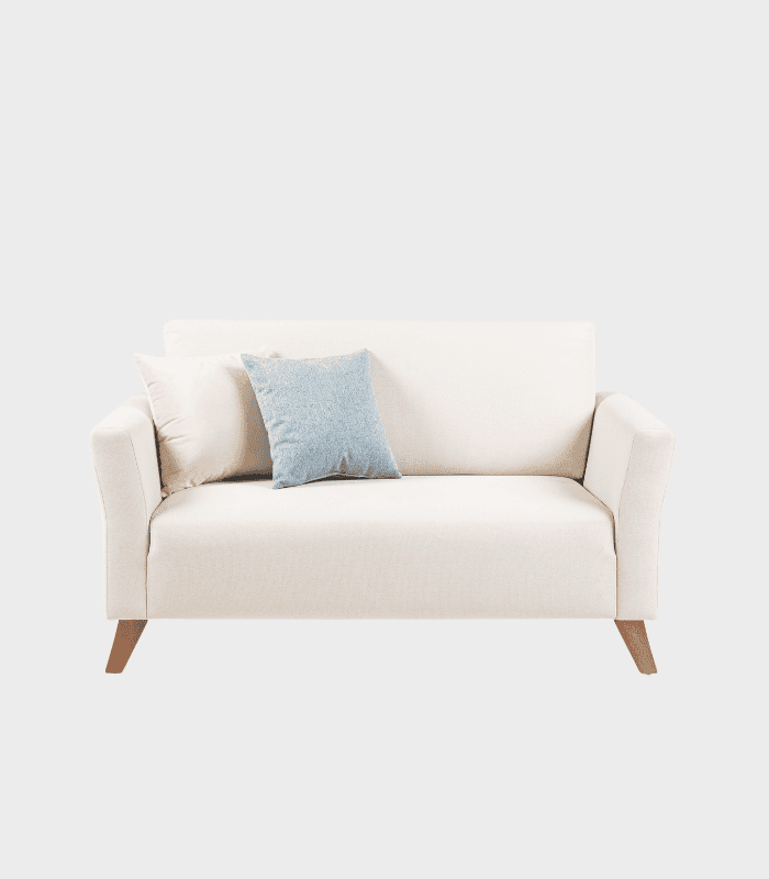 Chaiselongue beige con cojines decorativos, ideal para salón o sala de estar moderna y acogedora. Diseño elegante combina funcionalidad con estilo en muebles para el hogar.
