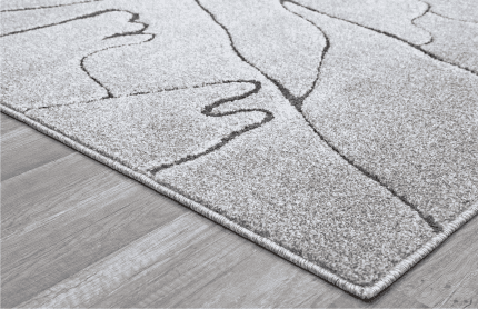 Alto texto: Alfombra beige con líneas curvas y detalles geométricos, ideal para decorar espacios modernos y acogedores en el hogar u oficina.