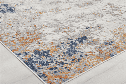 Suelo con alfombra moderna en tonos grises, azules y naranjas, decorada con muebles de Zona Muebles, incluyendo sillones y escritorios, ideal para decorar espacios elegantes y acogedores.