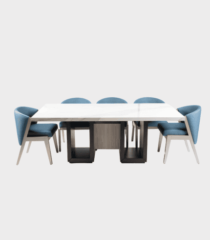 Mesa de comedor moderna con sillas acolchadas en tono azul, diseño elegante y funcional para espacios de estilo contemporáneo.